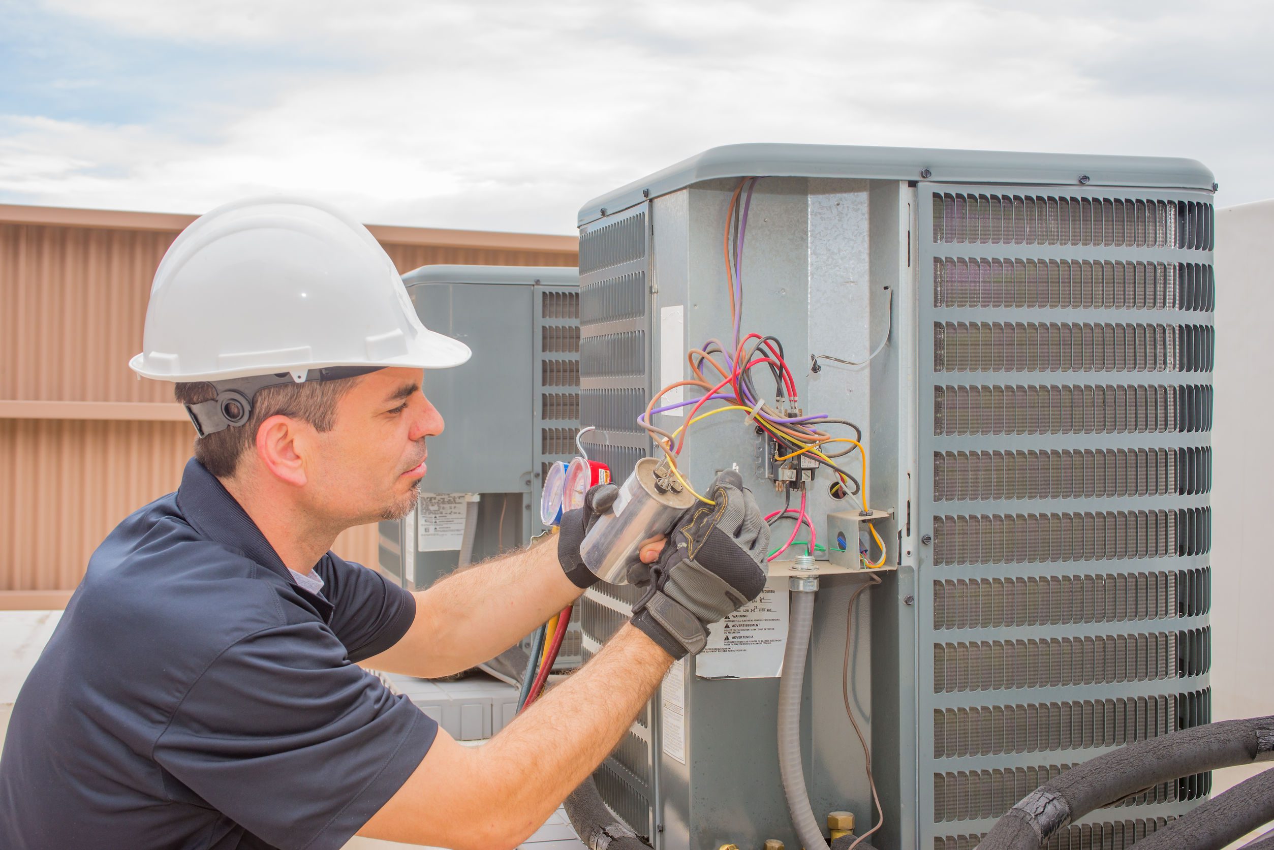 a technician works on a heat pump repair in colorado springs