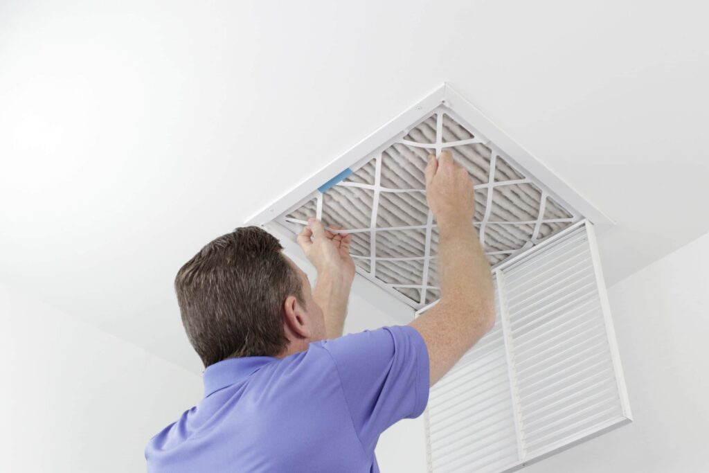 man replacing ac air filter in colorado springs